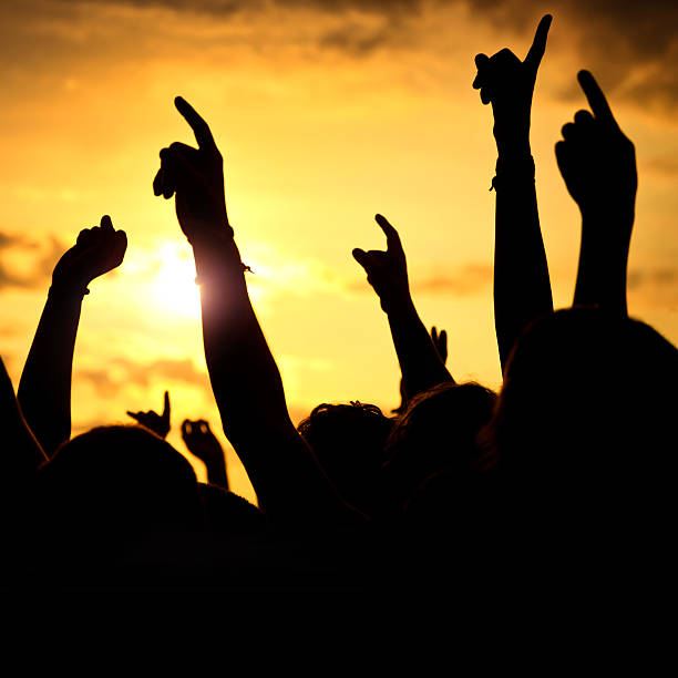 istock hands up in a open air rock festival 185116652