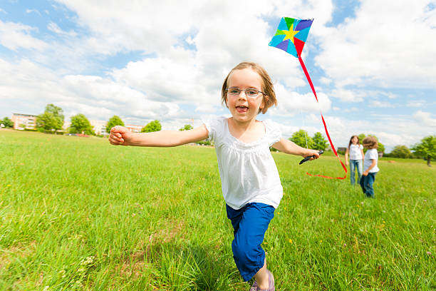 istock little girl flying a kite 185117006