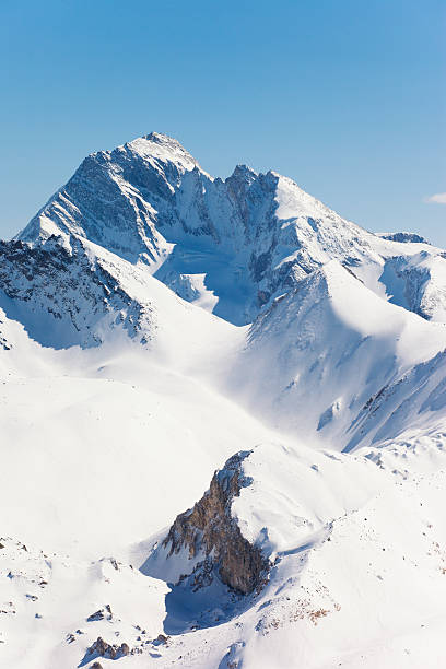 Val Thorens "Val Thorens, located in the Tarentaise Valley, Savoie, French Alps, is the highest ski resort in Europe at 2300 m altitude. The resort forms part of the 3 vallAes linked ski area which, with over 600 km of piste, is one of the largest linked ski area in the world.More photos from European Alps:" top of ski mountain stock pictures, royalty-free photos & images