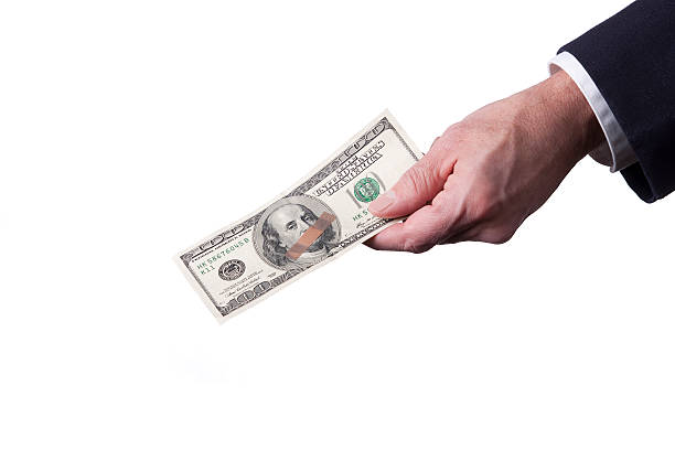 istock Businesman's Hand Holding a Bandaged 100 Dollar Bill 185117885