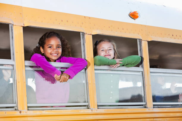 istock Children looking out school bus window 185118039