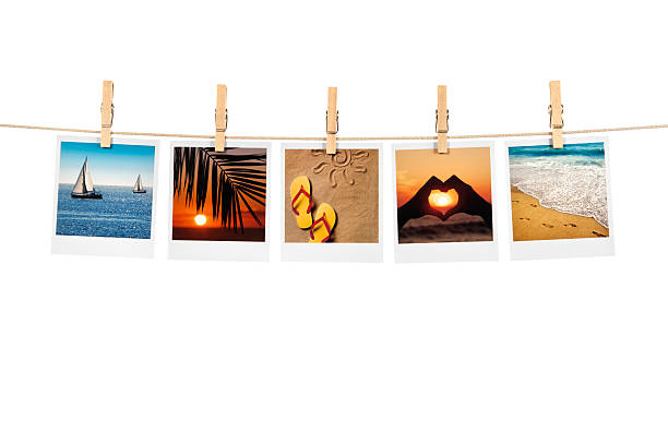 Holiday concept Print vacation photos on the clothesline against white background. All print photos was taken by me. clothesline photos stock pictures, royalty-free photos & images