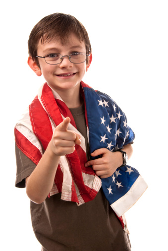 School age boy with an American flag draped over his shoulders pointing like Uncle Sam.Similar Images: