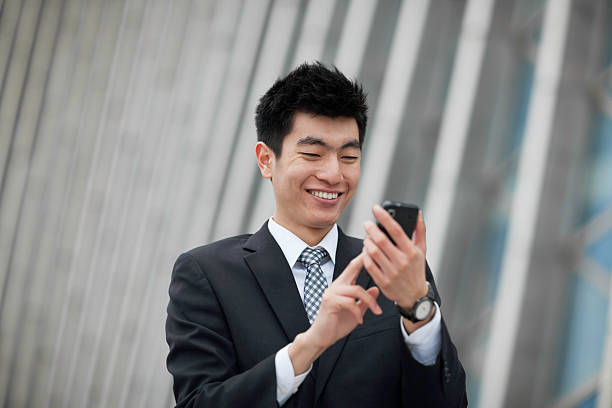 istock Young businessman texting on cellphone 185118600