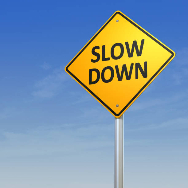 Slow Down Warning Sign Road Warning Sign - Slow Down.Digitally generated 3d image. slow stock pictures, royalty-free photos & images