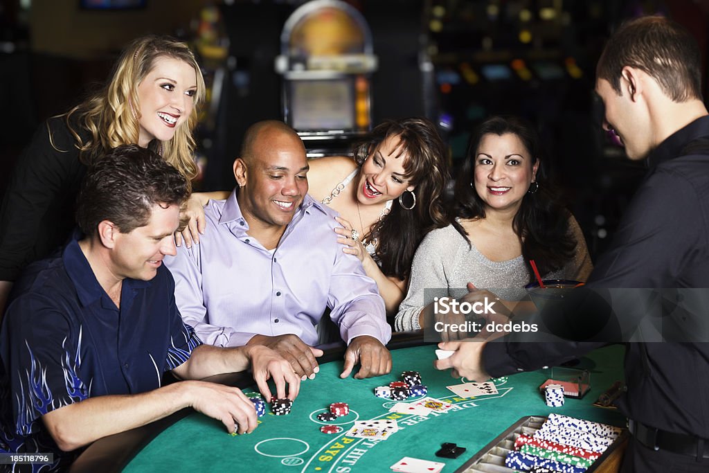 Diverse Group of People Playing Blackjack In a Casino A diverse group of people playing Blackjack inside a casino. Casino Stock Photo
