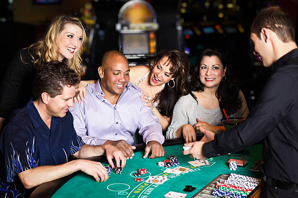 Diverse Group of People Playing Blackjack In a Casino stock photo