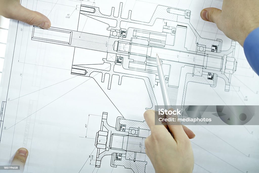 Examining blueprint Close-up of a blueprint being examined Analyzing Stock Photo