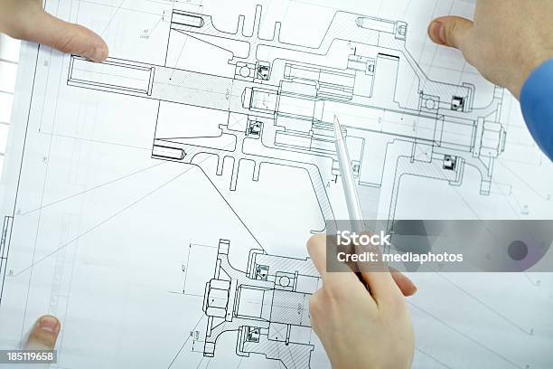 Examining Blueprint Stock Photo - Download Image Now - Analyzing, Architect, Blueprint