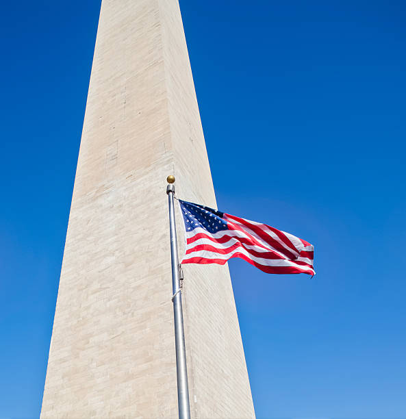 istock Washington Monument and Flag under Brilliant Blue Sky 185119866