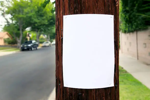 Photo of Blank piece of paper hanging on the telephone pole 