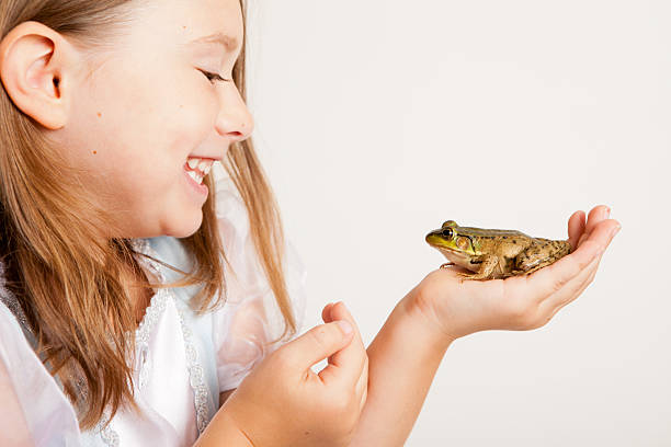 istock Color Image of Young Princess Smiling at Frog 185120292