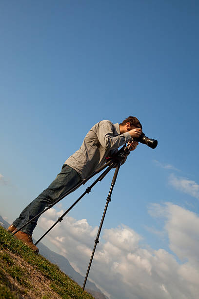 istock young  photographer with the camera on a tripod. 185120866