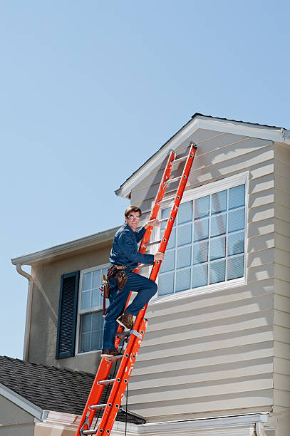 istock Handyman In Uniform Climbing Ladder 185121357