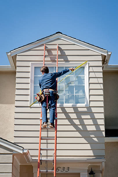 Handyman In Uniform Measuring "Male caucasian handyman in uniform and tool belt, measuring the 2nd story window of a Cape Cod style house.Take a look at our lightbox's of other related images." clothing north america usa massachusetts stock pictures, royalty-free photos & images