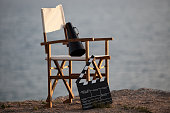 Director's chair in outdoor with megaphone and film slate.