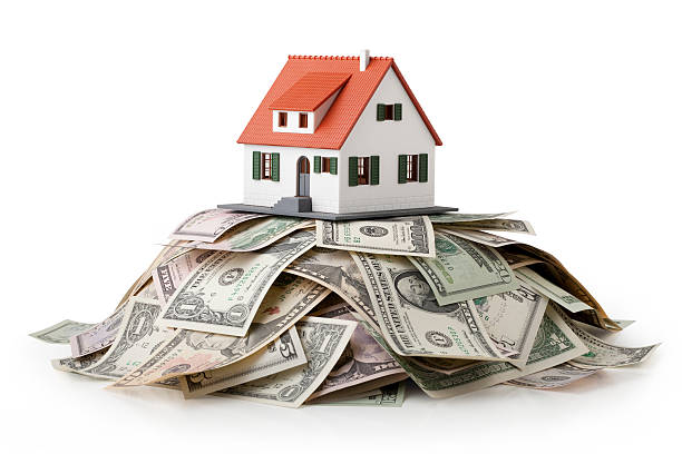 House and money. Miniature model house standing on a heap of dollar bills. Photo with clipping path.Some similar pictures from my portfolio: money house stock pictures, royalty-free photos & images