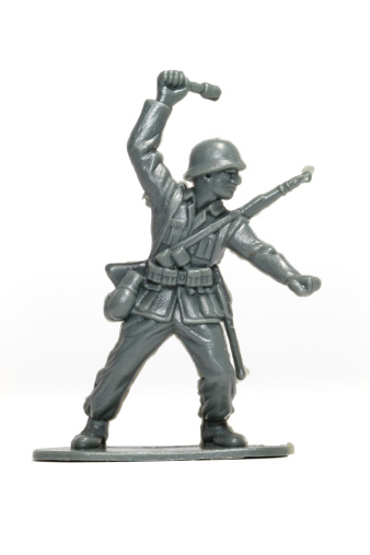 A grey soldier throwing a grenade.