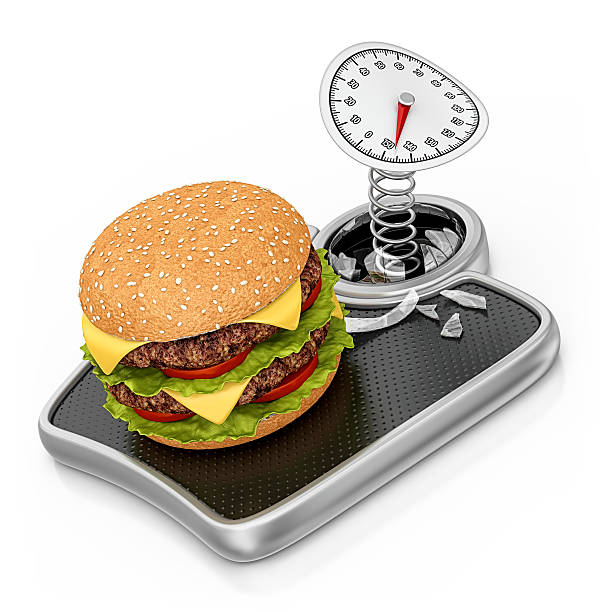 A young african amercian woman eyeing the huge burger in her hand hungrily