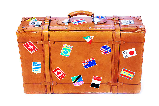 istock Old Leather Suitcase with International Travel Sticker Labels on White 185122330