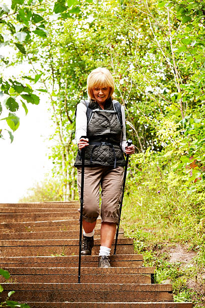 istock Elderly woman hiking with walking stick 185122721