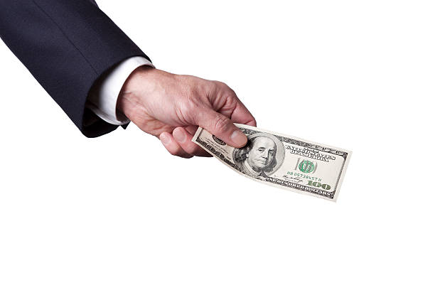 Businesman's Hand Holding a US 100 Dollar Bill stock photo