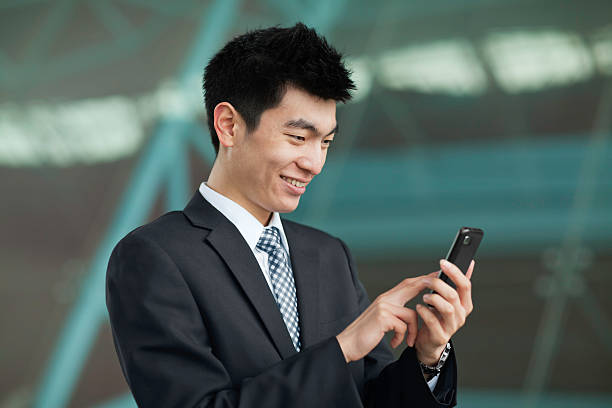 istock Young businessman texting on cellphone 185123463