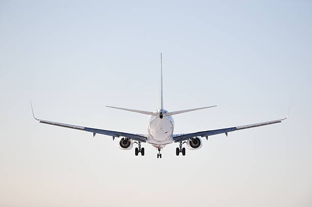 Airplane taking off or lands against bright sky