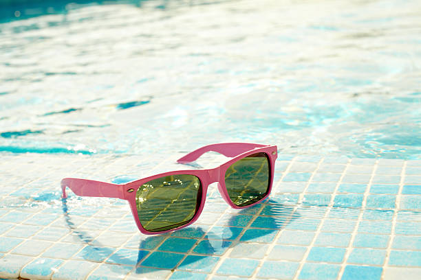 istock Sunglasses at swimming pool 185124334