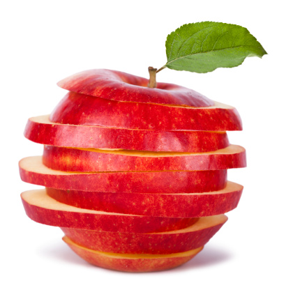 Red apples with green leaf and half slice on wooden table background. Top view. Flat lay.