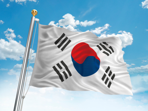 Waving South Korean flag against cloudy sky. High resolution 3D render.