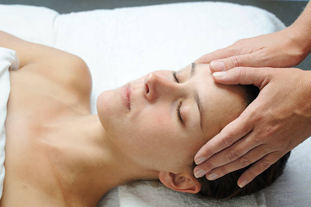 istock Young woman receiving head massage 185124777