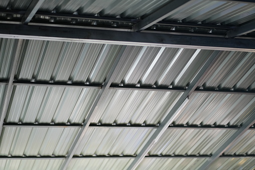 View from below on new ceiling; pillars with steel joints are painted in white.