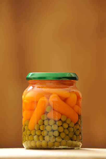 glass jar with peas and carrots