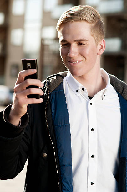 istock Young man having fun with a smart phone 185125229