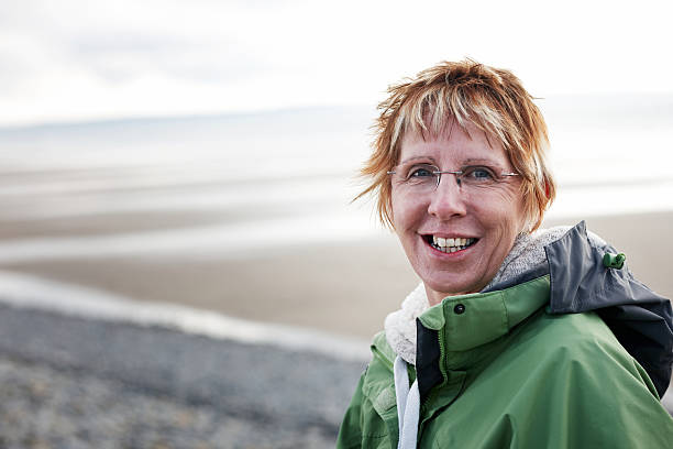 istock Mature woman at the beach 185125457