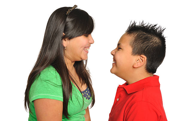 istock Brother and sister facing each other having fun 185125528