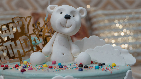 Decoration details of a birthday cake made for little boy girl, in blue and white. Teddy bear Birthday cakes
