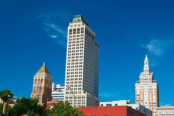 Tulsa skyline buildings "Tulsa, Oklahoma downtown office buildings, including the Mid-Continent tower in the middle, 320 South Boston building to the right, and the Philtower building to the left." tulsa landmark stock pictures, royalty-free photos & images