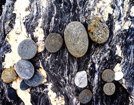 Retaining wall made of stones, boulders. Stone of volcanic rocks, granite, basalt, gabro. Bank protection on the sea beach. Protection of the coast from destruction by waves. Waterworks.