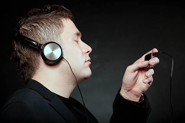 istock young man with headphones use mp3 music player 185129267