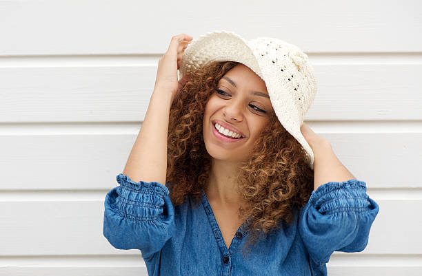 istock Attractive woman wearing hat and smiling on white background 185130122