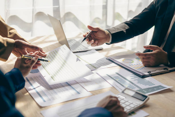 istock Group of business people are meeting to analyze data for marketing plan, office workers work in team meeting with project planning documents on conference table. 1851308942