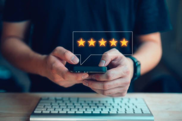 istock customer service satisfaction survey. man hand pressing on smartphone screen with gold five star rating feedback 1851355008