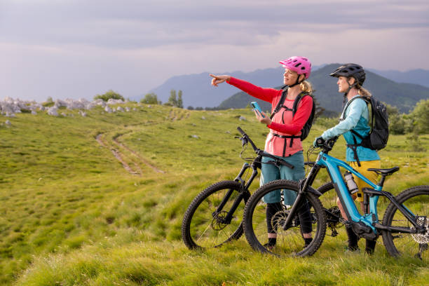 istock Female cyclists taking break while riding bike 1851364356