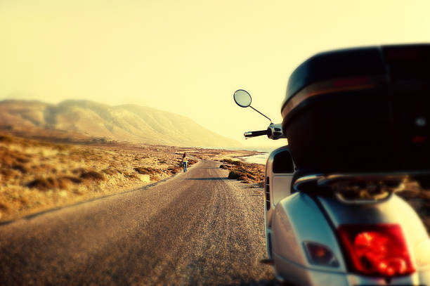 istock Scooter on a tarmac country road 185139313