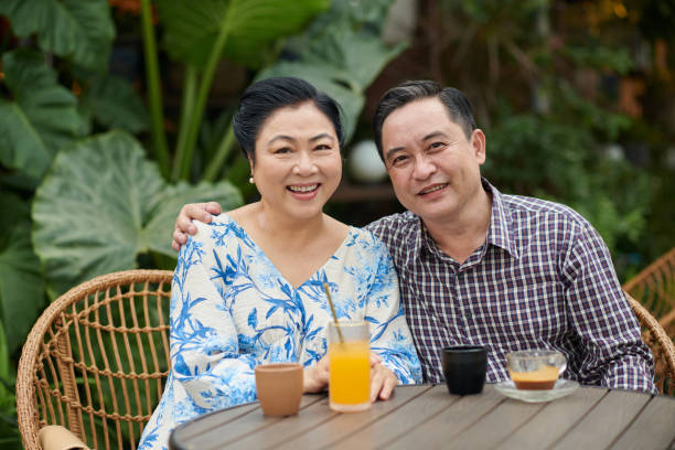 istock Smiling Aged Couple Sitting at Coffeeshop Table 1851415064