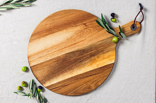 Circle wooden cutting or serving board, olives and olive branches, template for product display