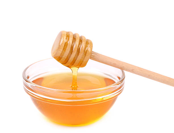 istock Bow of honey and wooden spoon. 185142471
