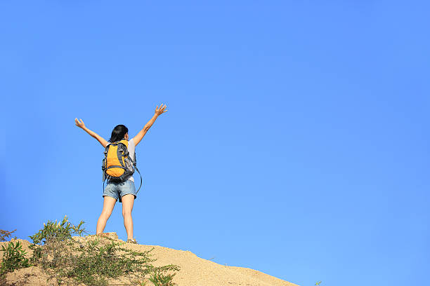 istock woman hiker excited mountain peak 185142687